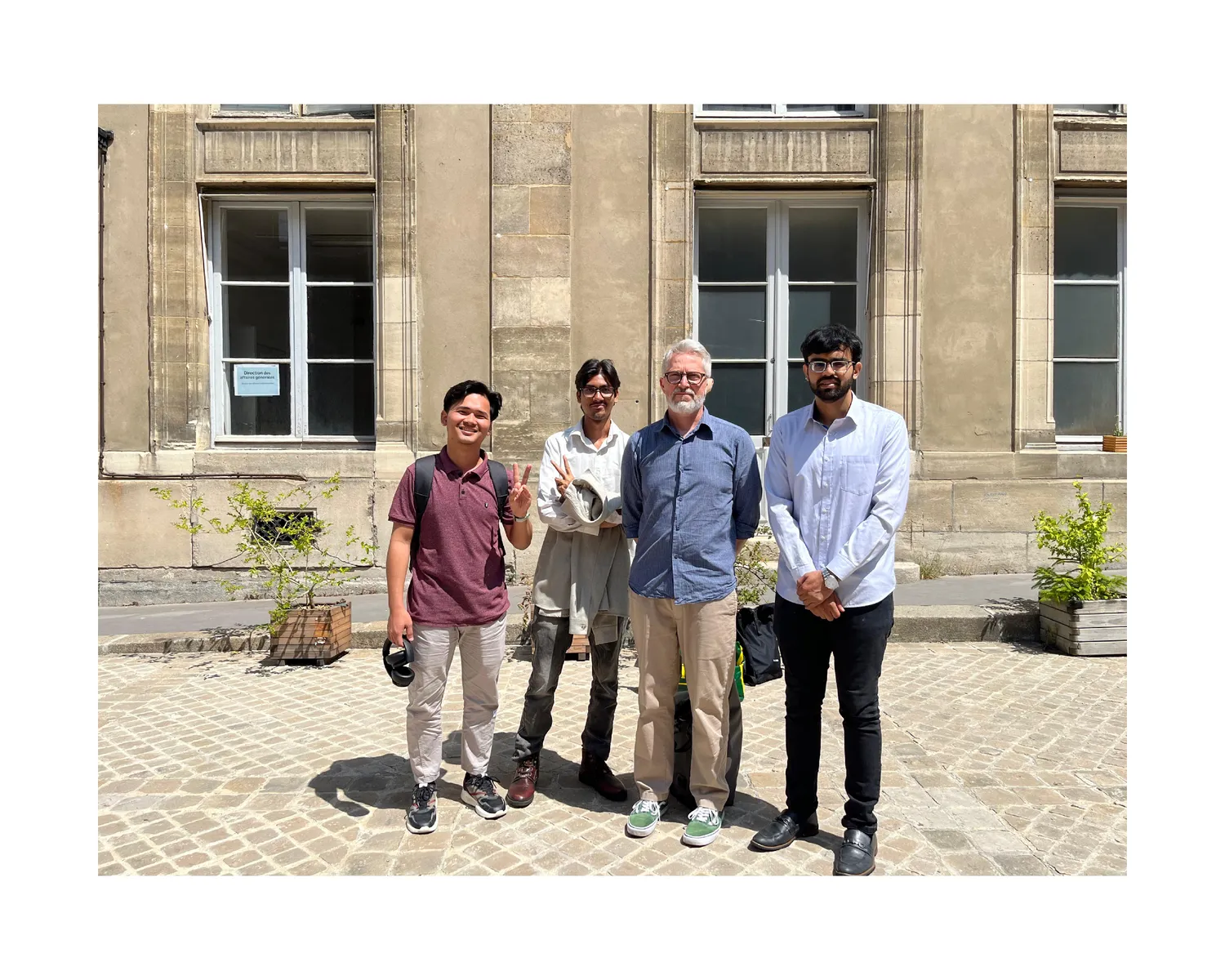 Classmates and a professor in a sunny courtyard in Paris