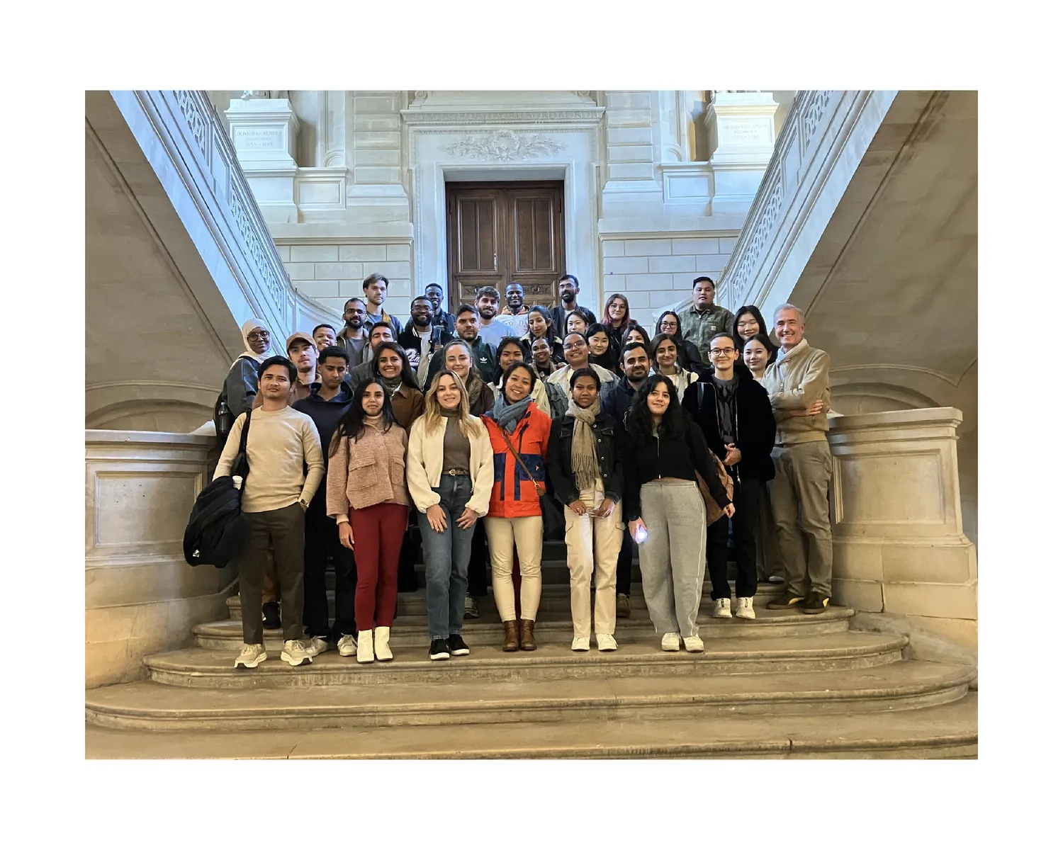 Large group photo with CNAM classmates on a grand staircase