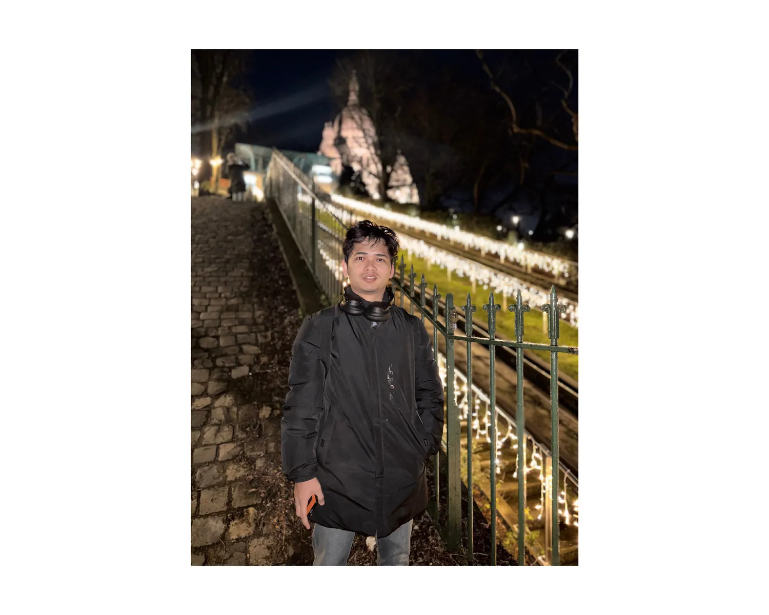 Night walk near a lit-up Paris monument with string lights